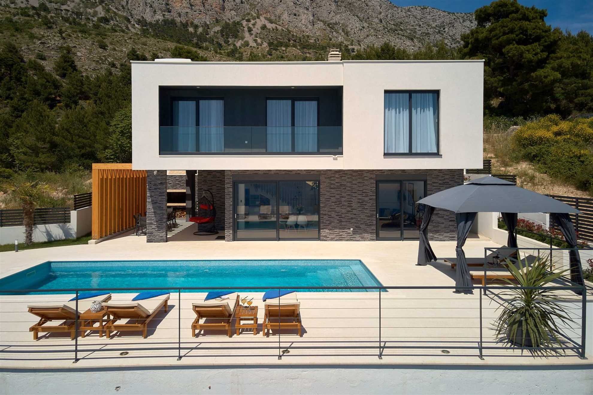 A modern villa with a pool and an amazing sea view