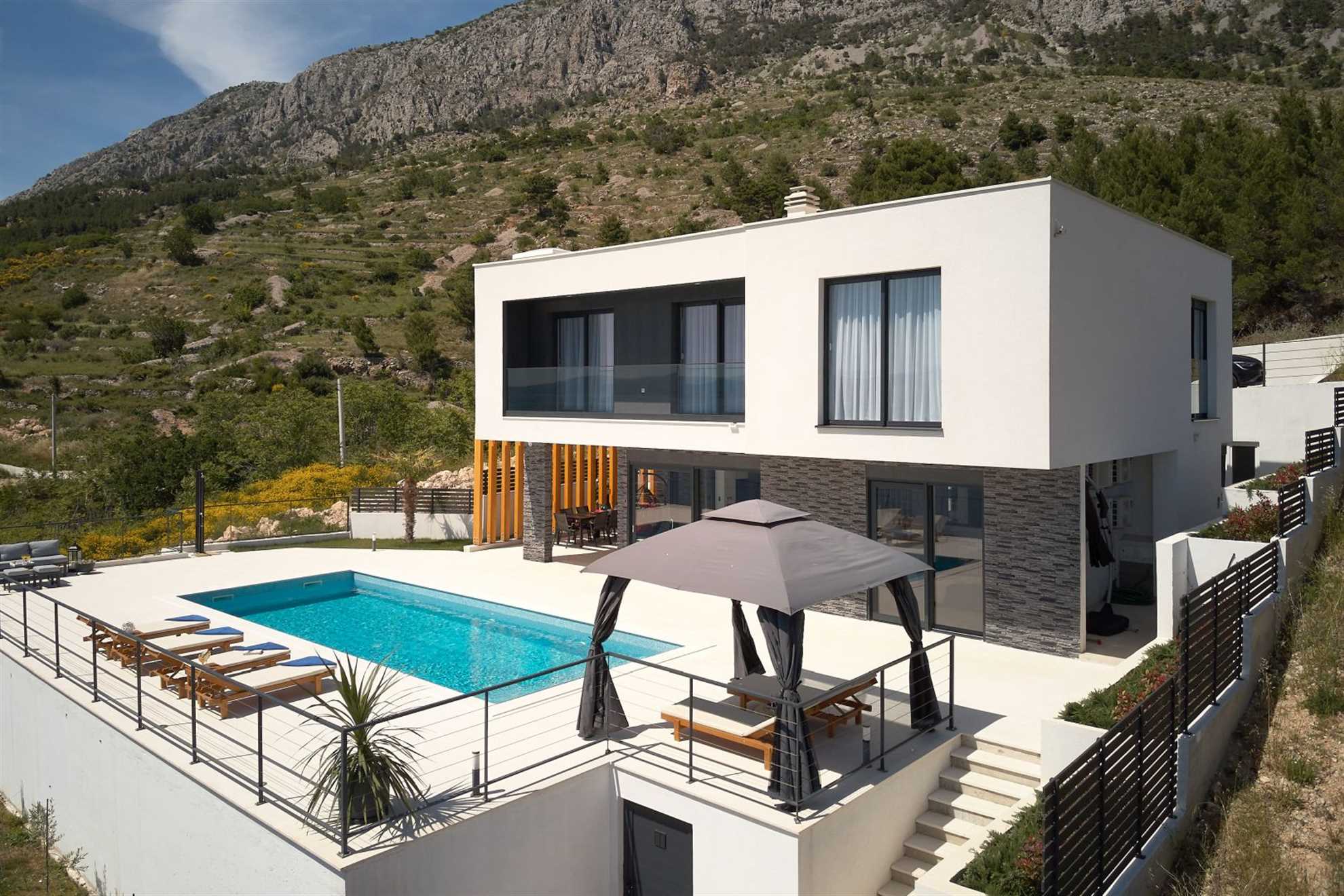 A modern villa with a pool and an amazing sea view