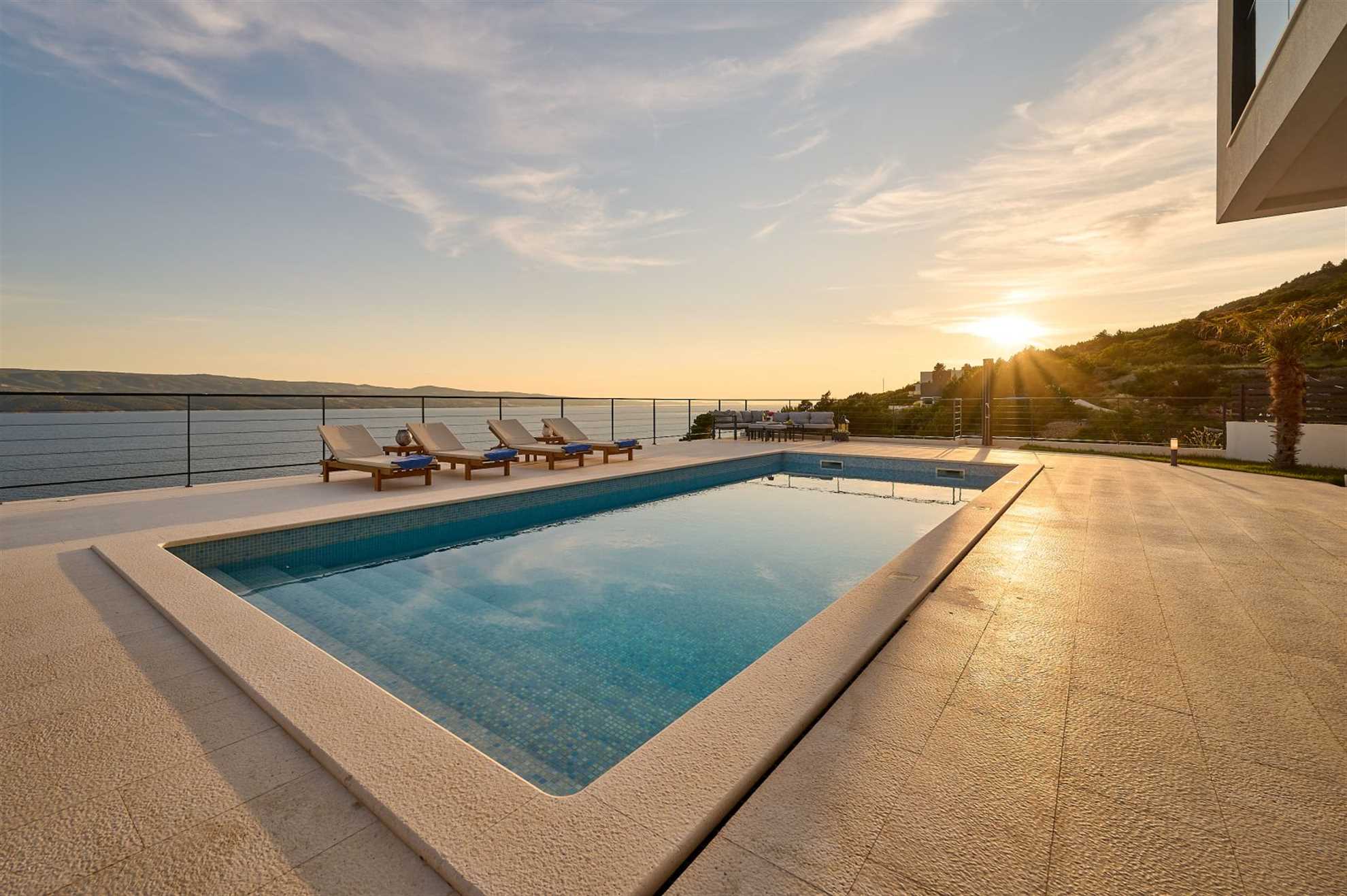 A modern villa with a pool and an amazing sea view