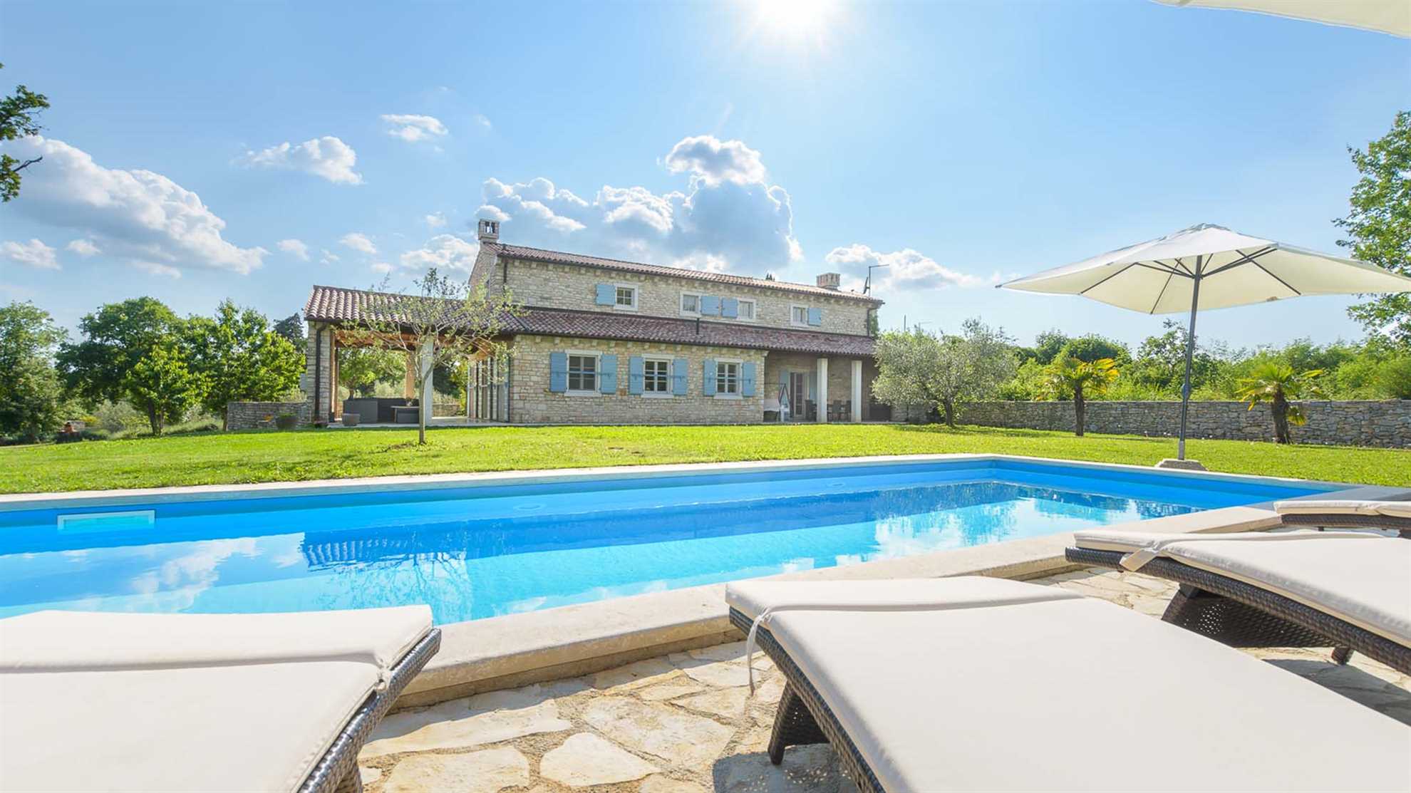 A traditional, stone villa in Marčana with a pool and children's playground