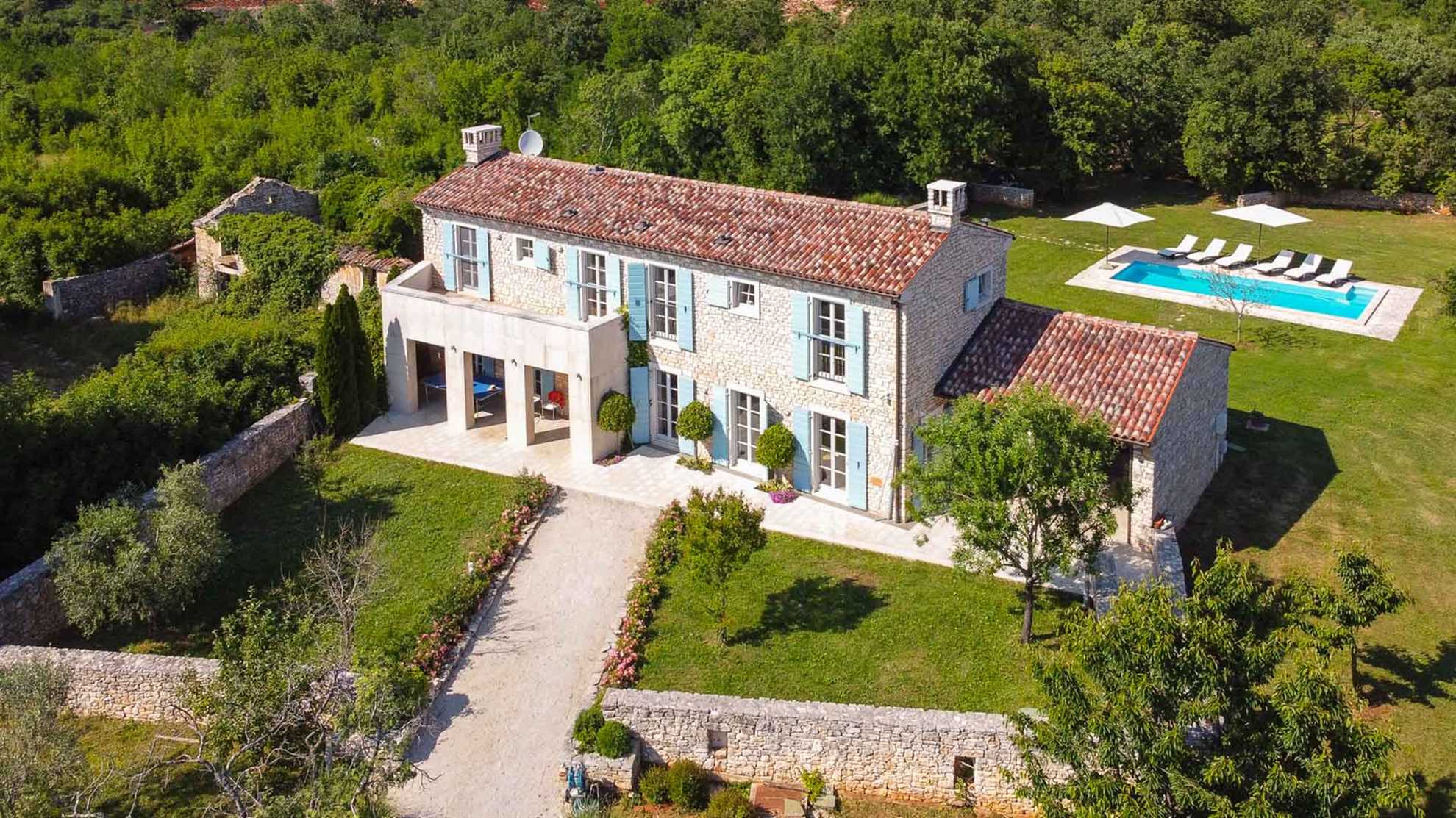 A traditional, stone villa in Marčana with a pool and children's playground