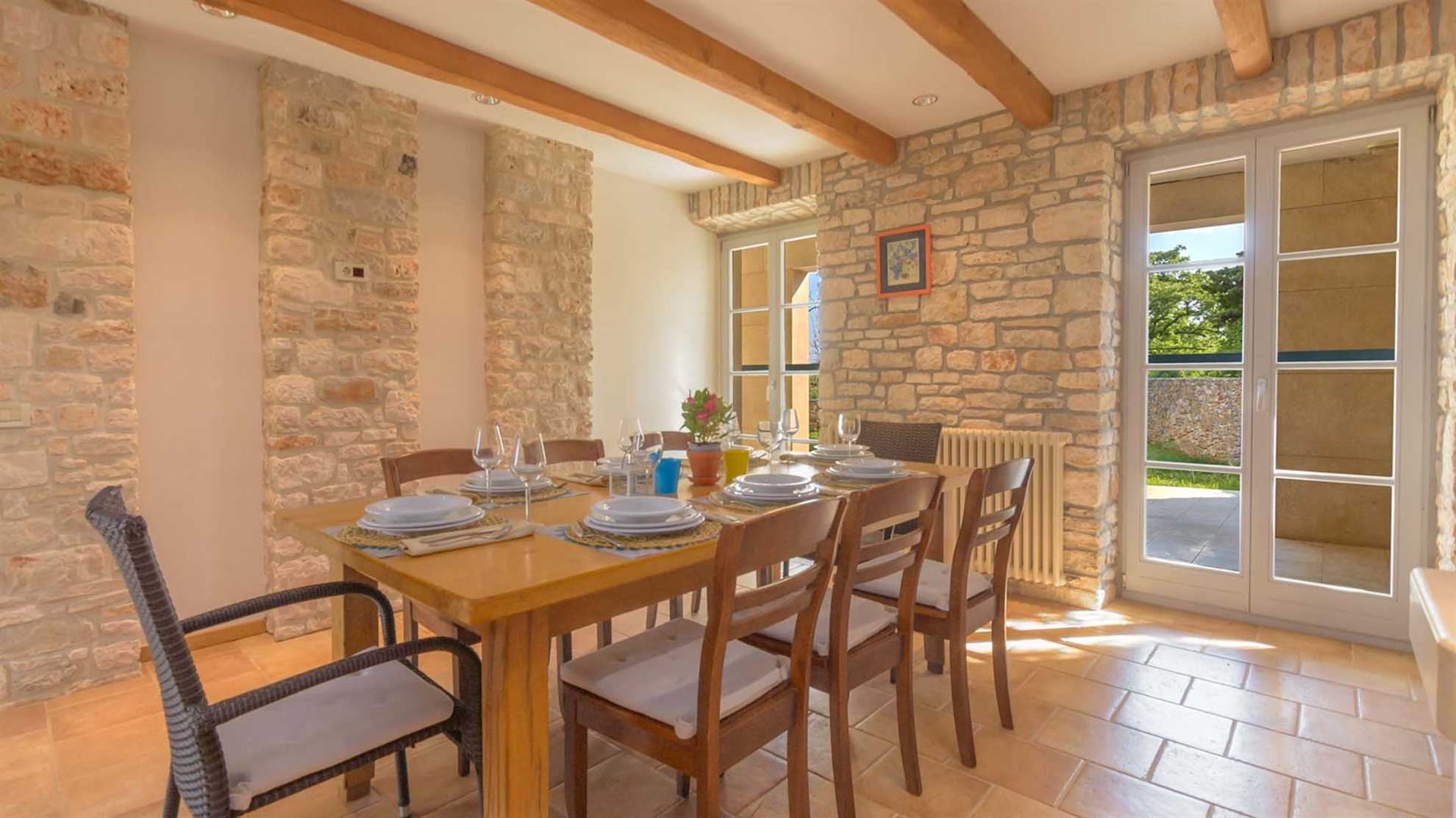 A traditional, stone villa in Marčana with a pool and children's playground