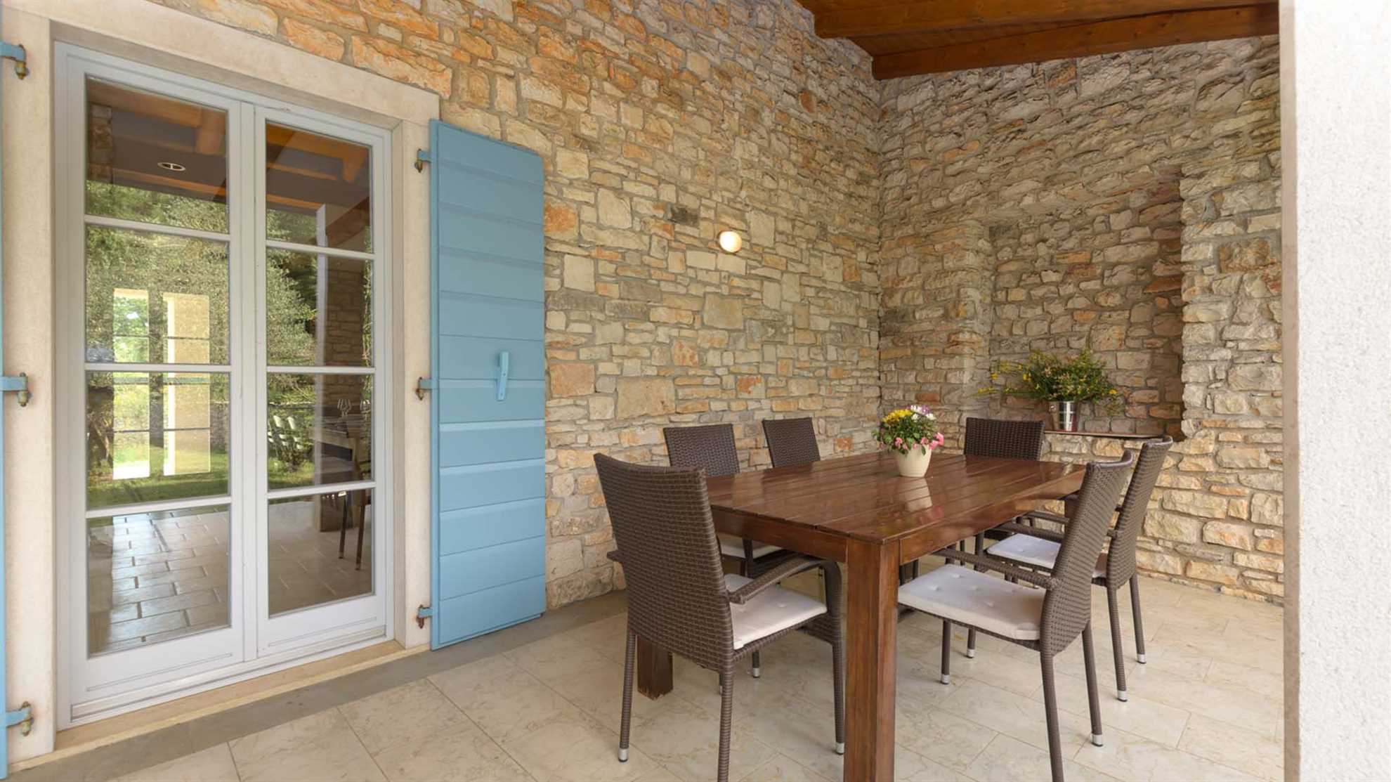 A traditional, stone villa in Marčana with a pool and children's playground