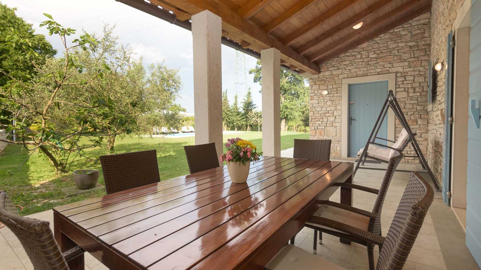 A traditional, stone villa in Marčana with a pool and children's playground