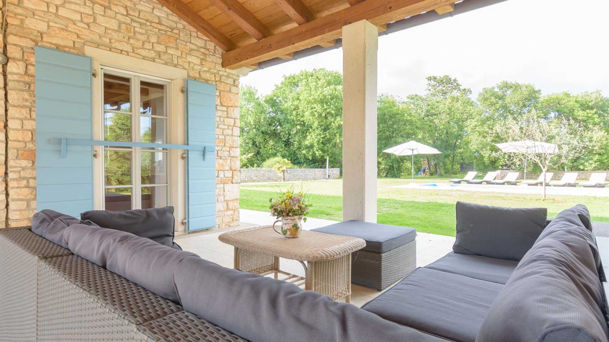 A traditional, stone villa in Marčana with a pool and children's playground