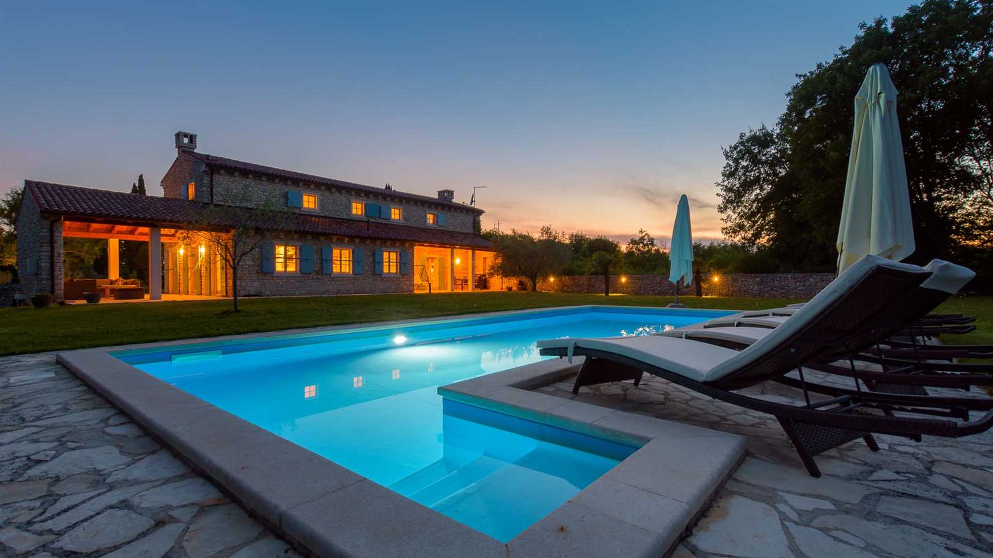 A traditional, stone villa in Marčana with a pool and children's playground