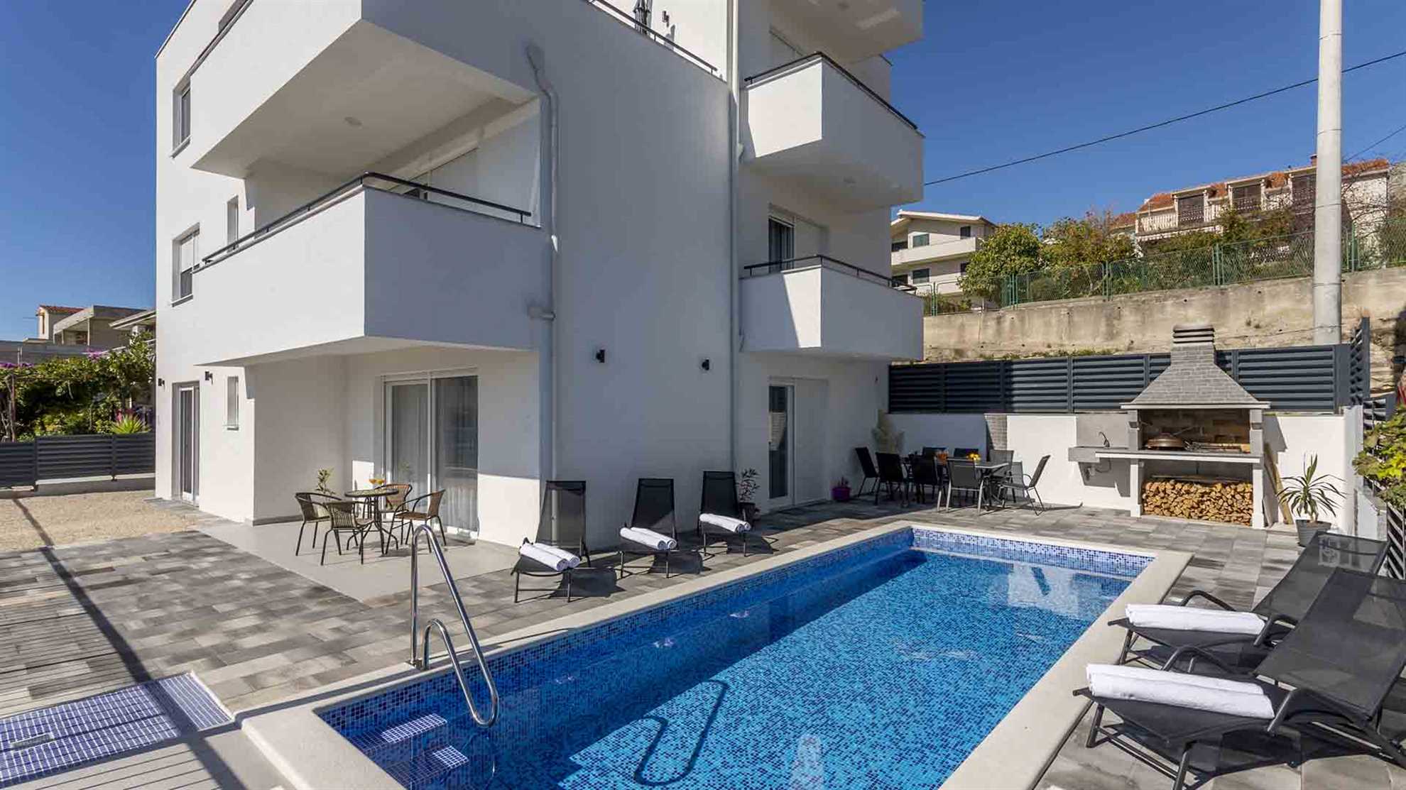 A modern villa in Podstrana with a pool