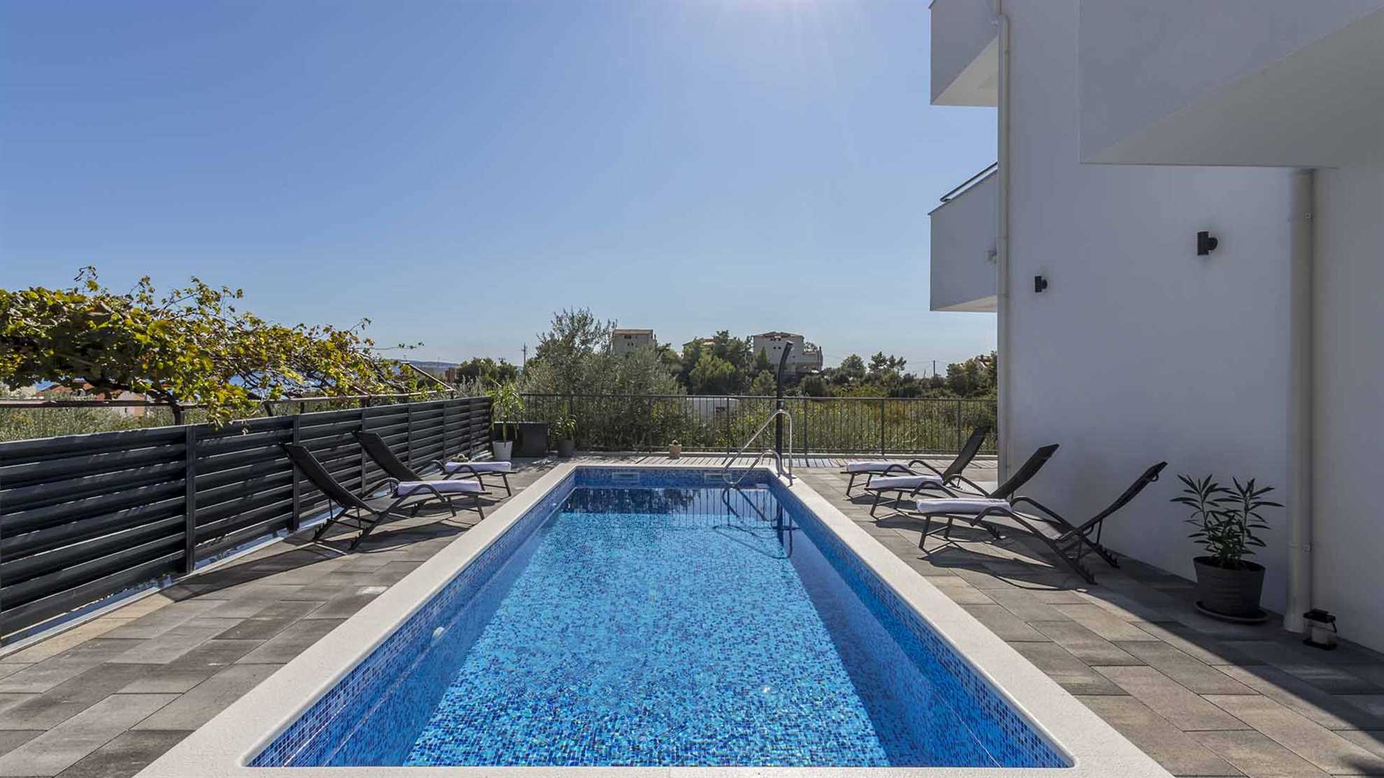 A modern villa in Podstrana with a pool