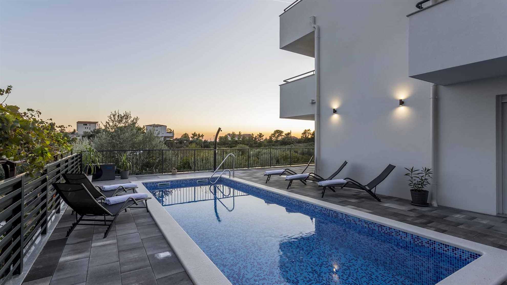 A modern villa in Podstrana with a pool