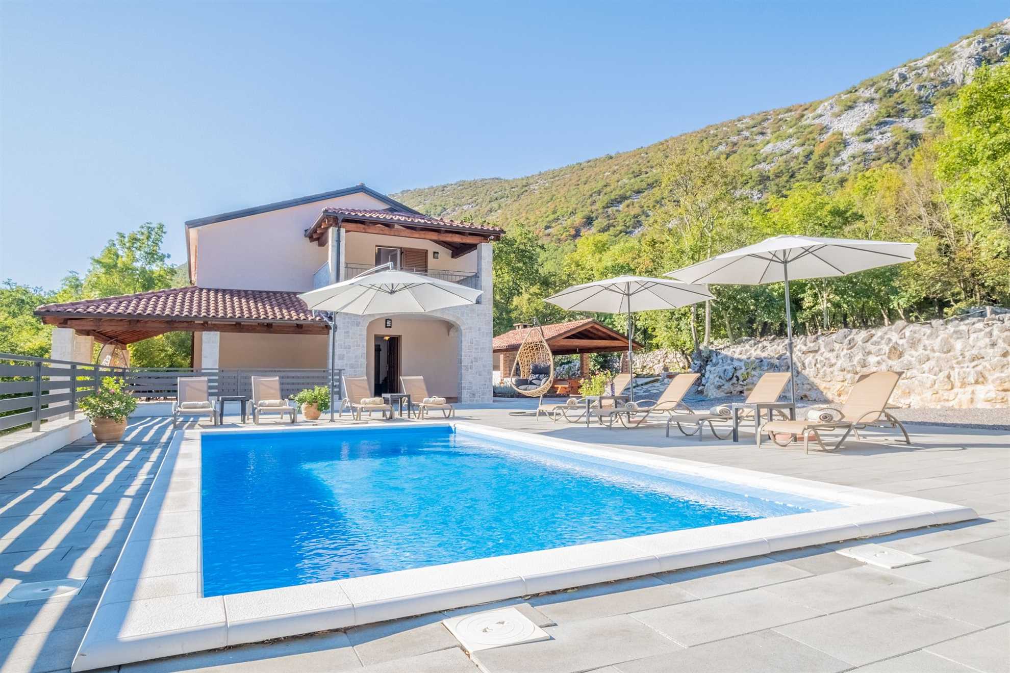 Traditional poolside villa surrounded by nature